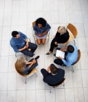 Top view of multi ethnic business people sitting in circle and discussing